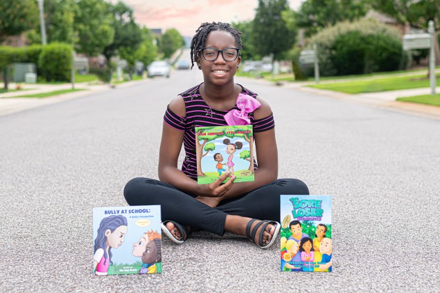 Gallant Kid Nia Mya Reese became an author at a young age. Here’s she’s sitting cross-legged with her 3 books.